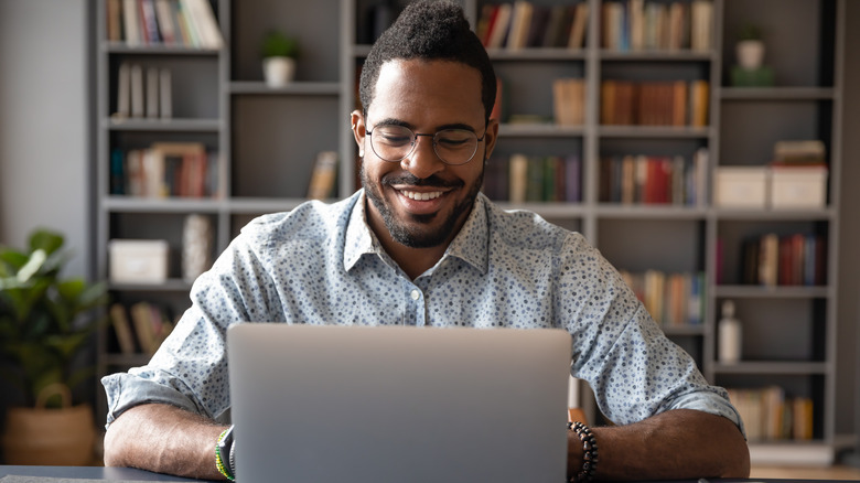 man sitting on laptop