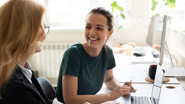 women smiling with laptop