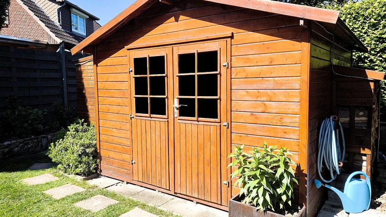 A wooden shed in a yard