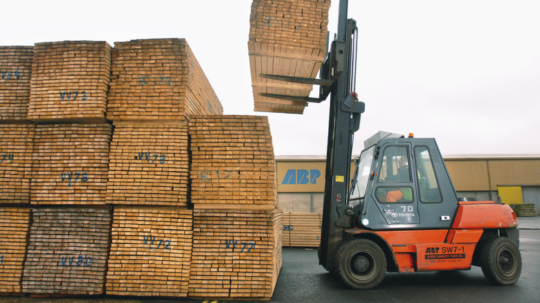 Pallets of wood with loader
