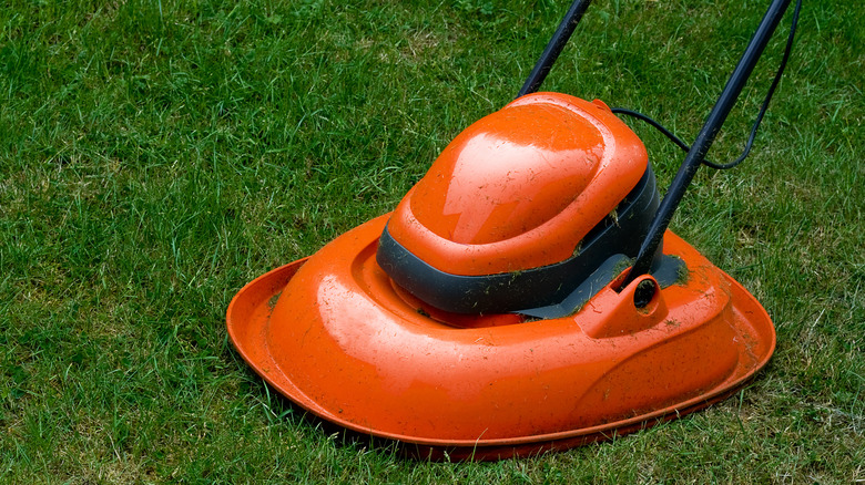 an orange hover mower on grass