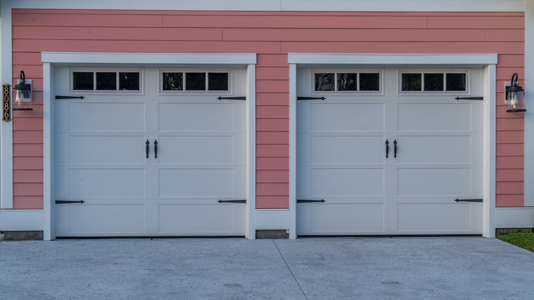 Home with pink vinyl siding around garage door