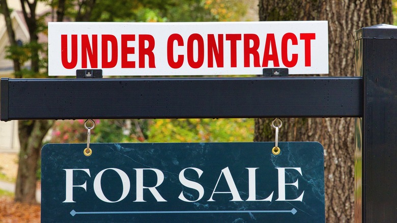 For sale sign with "under contract" added on top