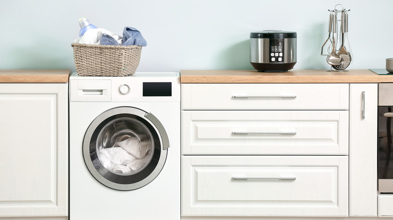 Washing machine inside white kitchen