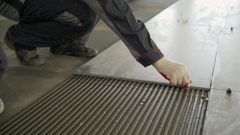 Person placing floor tile