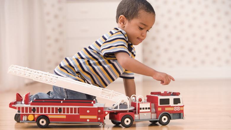 Boy playing with truck