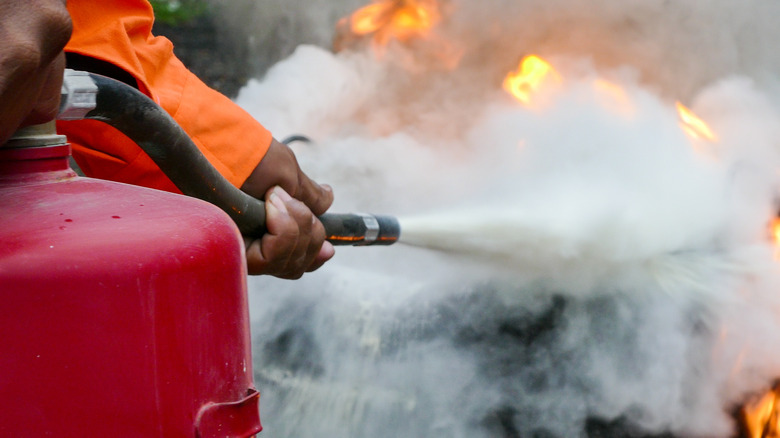 spraying powder from fire extinguisher