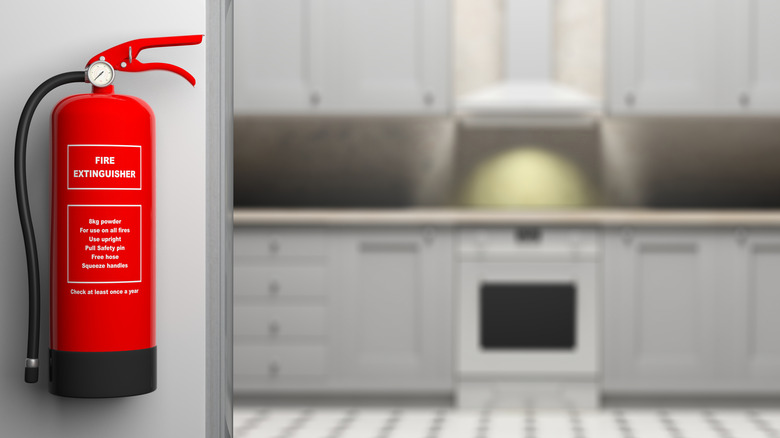 fire extinguisher on wall by kitchen