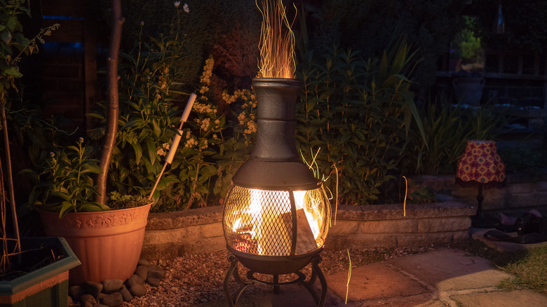 Flaming chiminea in garden