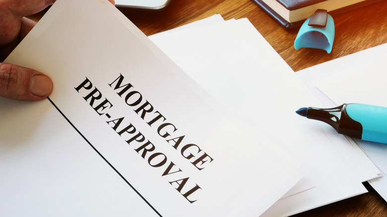 man holding mortgage pre-approval document 