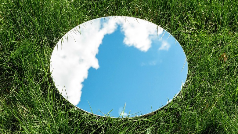 Frameless mirror on grass