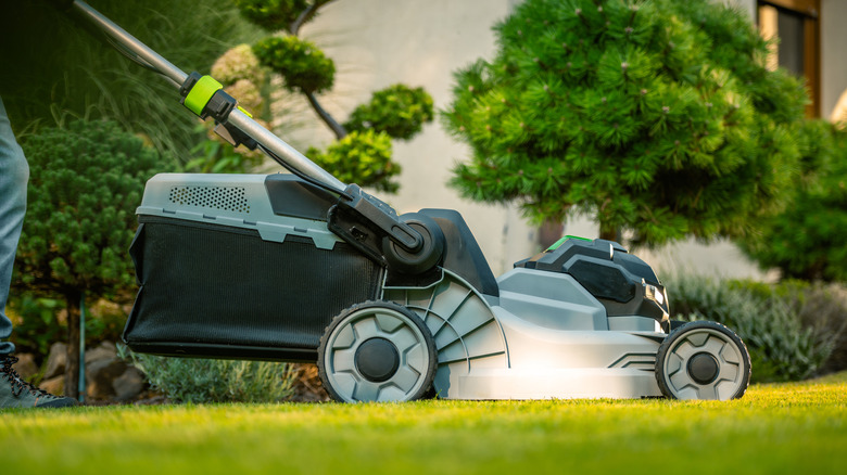 A blue electric lawn mower