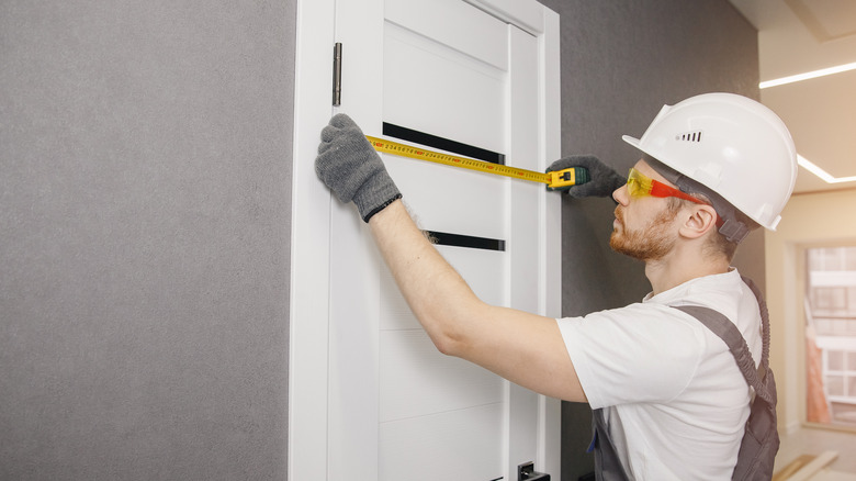 Carpenter measuring a closet