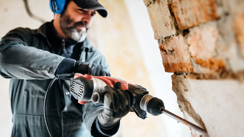 Man drilling into a wall