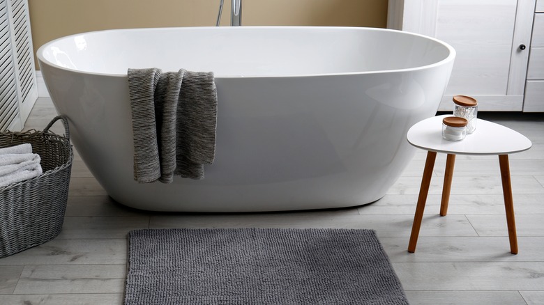 standalone bathtub next to table