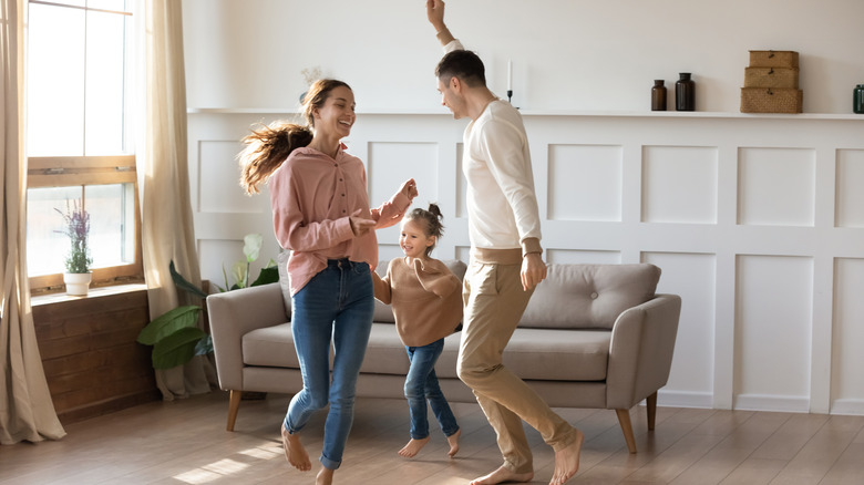 family dancing on laminate flooring