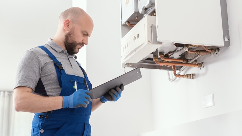 man look at clipboard during inspection