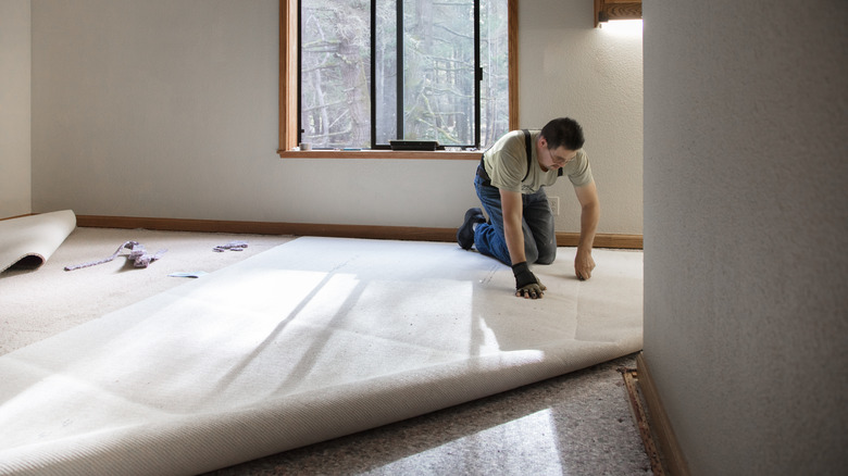 contractor installing carpet