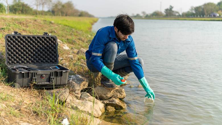 Technician takes water sample