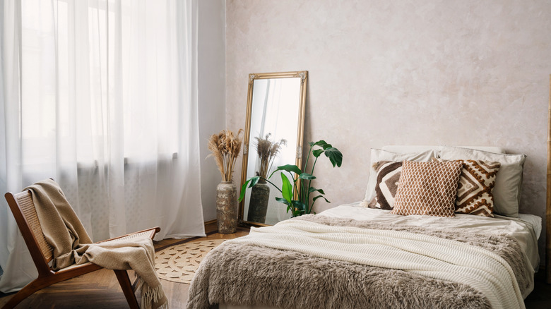 A large bed in a small, luxe-looking room