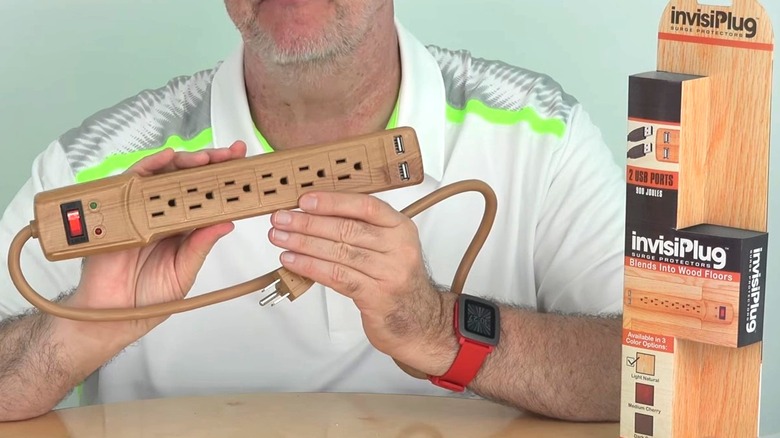 Man holding Invisiplug power strip