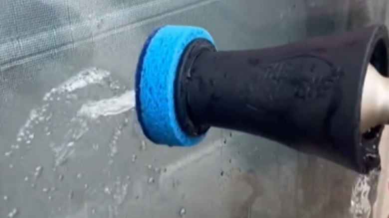 The Scrubbie cleaning a window