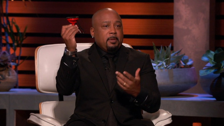 Daymond John holding a Yono Clip on Shark Tank