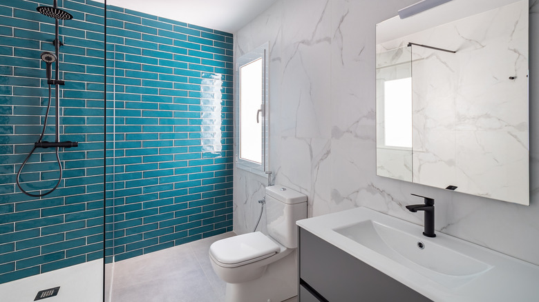 3/4 bathroom with blue tiles