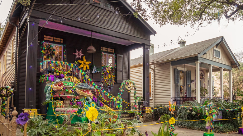 Two colorful shotgun houses in a New Orleans neighborhood, which are decorated for Marti Gras
