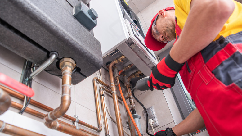 man checking furnace system