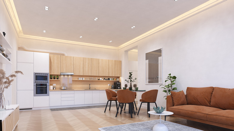 Simple, minimalist living room with recessed lighting fixtures on the ceiling.