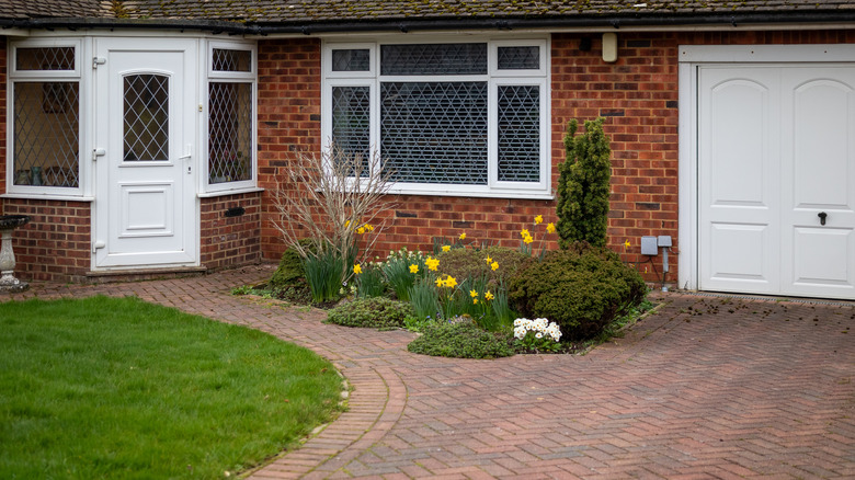 Brick cottage home with brick driveway