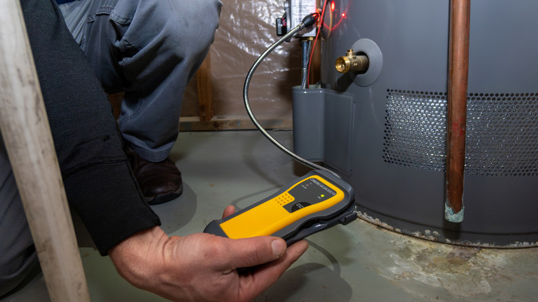 A technician monitoring the performance of a gas furnace