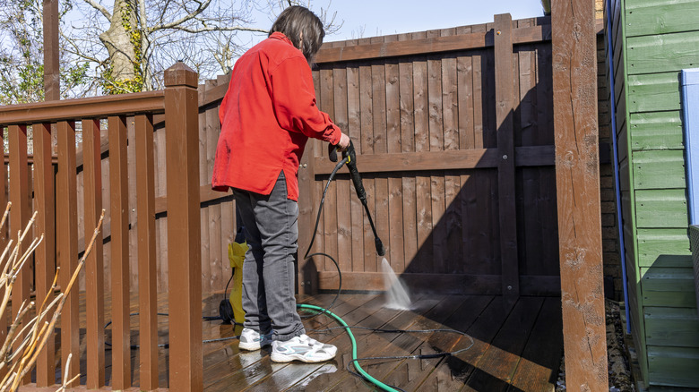 Woman cleaning wood deck