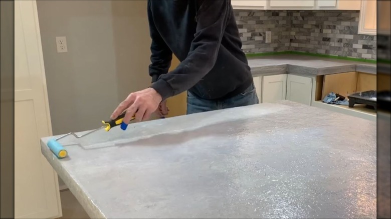man sealing concrete counter