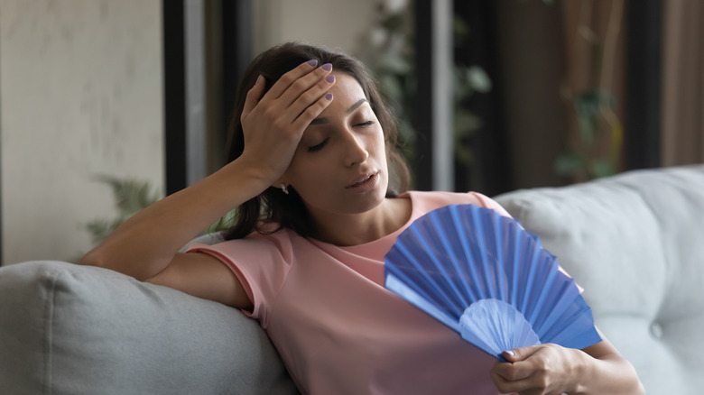 Woman fanning herself 