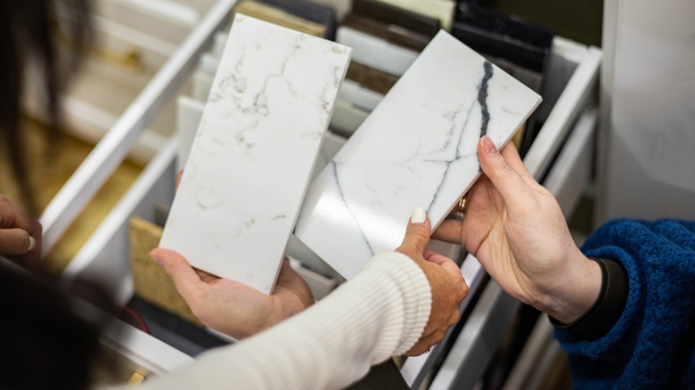 hands holding samples for countertops