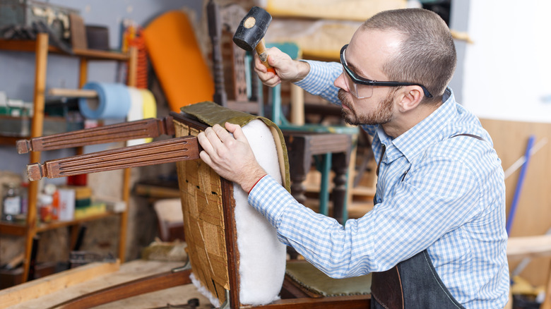 Professional reupholstering a dining chair