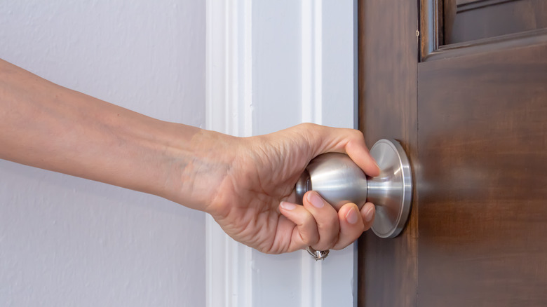 hand turning door knob