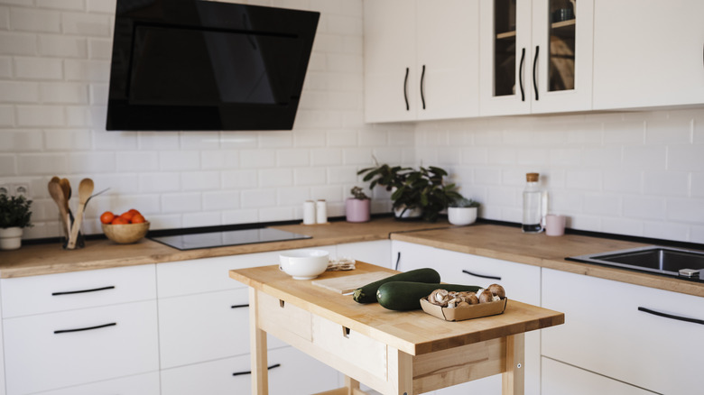 A television mounted on a wall in a kitchen
