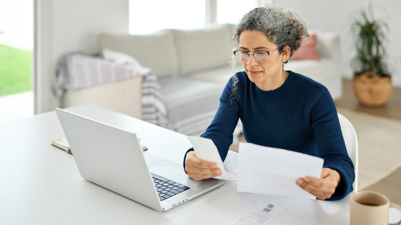 Woman paying bills on laptop