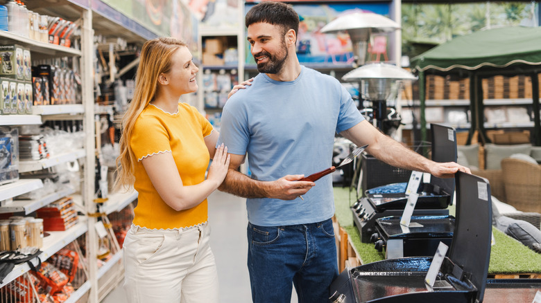 couple shopping for new grill