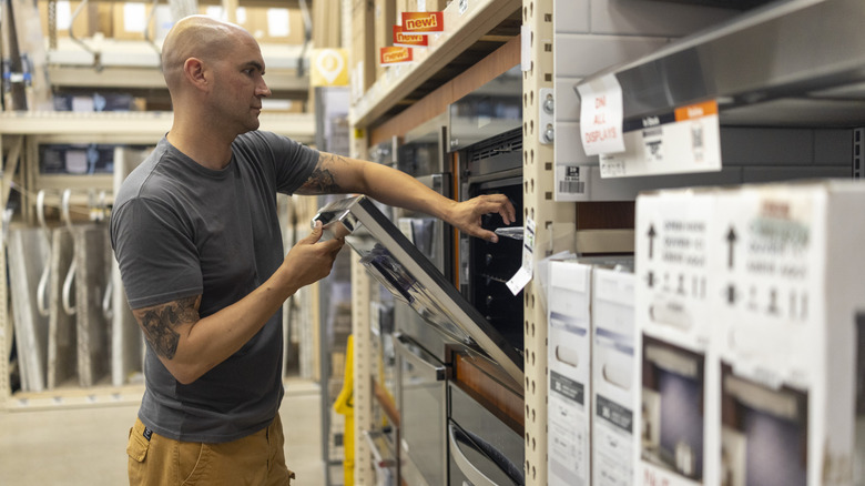 A man shopping for appliances at a warehouse store