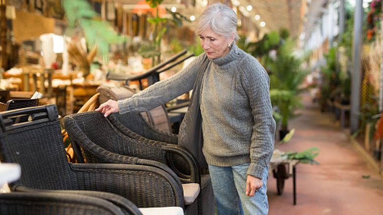 A happy couple looking at sofas to purchase in a store