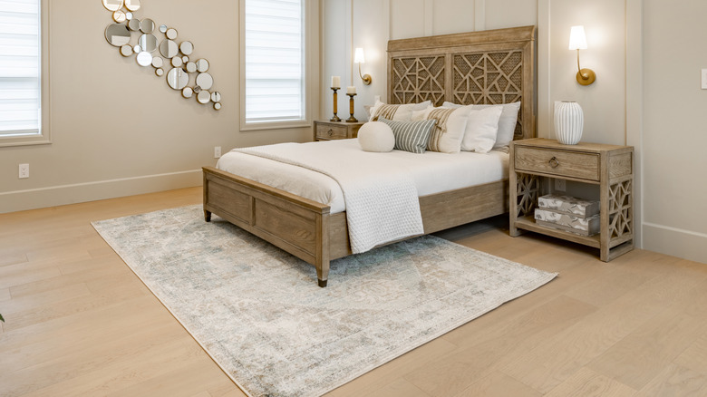 Bedroom with area rug halfway under the bed
