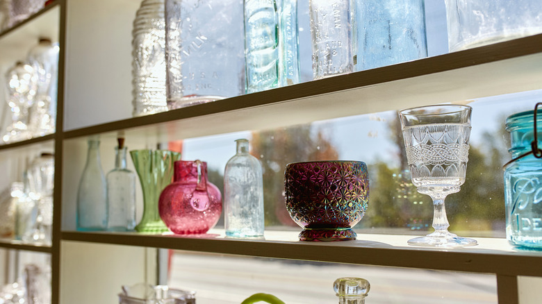Vintage glass on display in a sunlit window.