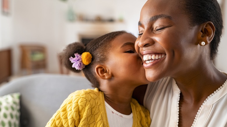 young girl kissing her mother