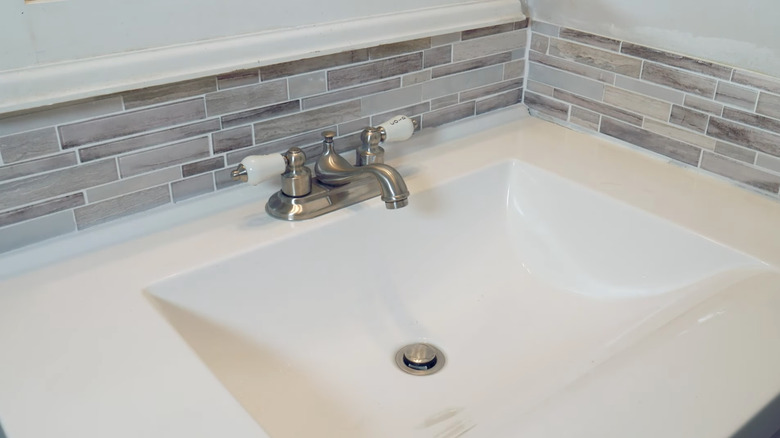 bathroom with grey glass tiles