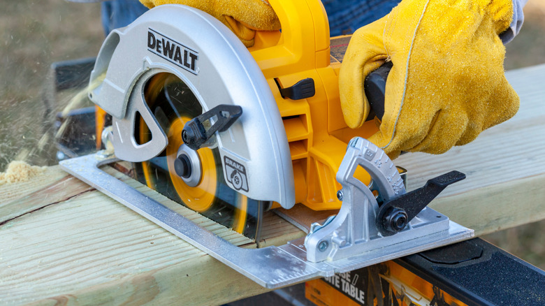 Cuitting a board with a DeWalt circular saw