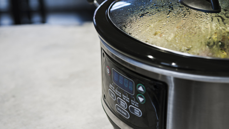 A slow cooker with condensation in the lid